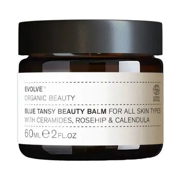 Amber glass jar of Evolve Organic Beauty Blue Tansy Beauty Balm with ceramides, rosehip, and calendula for all skin types, 60ml.